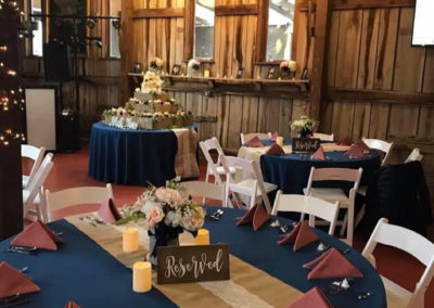 Gain a dynamic perspective of the porch wedding reception at Equus Run Vineyards' event barn. From a different angle and with different people, witness the captivating scene unfold as family members gather, enchanted by the live music.