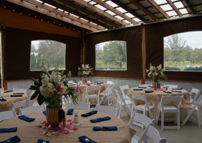 Experience the pinnacle of elegance as the sun's rays cast a soft, golden glow upon the wedding reception in our event barn at Equus Run Vineyards. The intimate setting, adorned with exquisite table settings, blossoming floral arrangements, and the joyful clinking of glasses, sets the stage for a memorable banquet.
