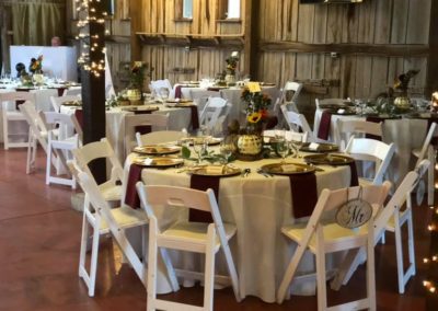 Step into an intimate banquet setting at Equus Run Vineyards, where elegant decor, soft lighting, and beautifully adorned tables create a warm and inviting atmosphere for cherished celebrations and special gatherings.